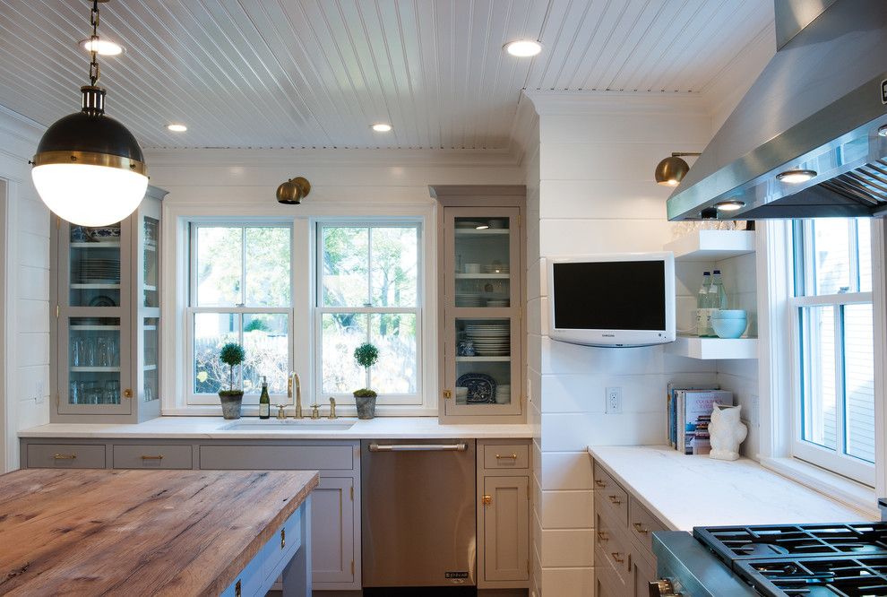Nora Lighting for a Farmhouse Kitchen with a Wood Floors and Farmhouse Kitchen with a Mid Century Twist by Crown Point Cabinetry