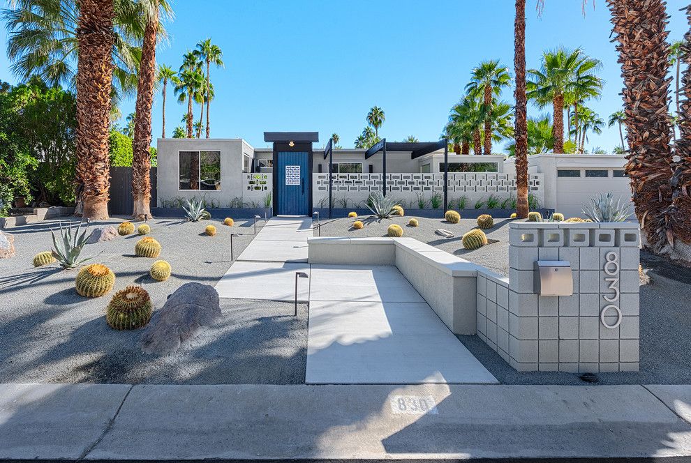 Norberts for a Midcentury Exterior with a Blue Door and Fair Palms   Front Yard by H3k Design
