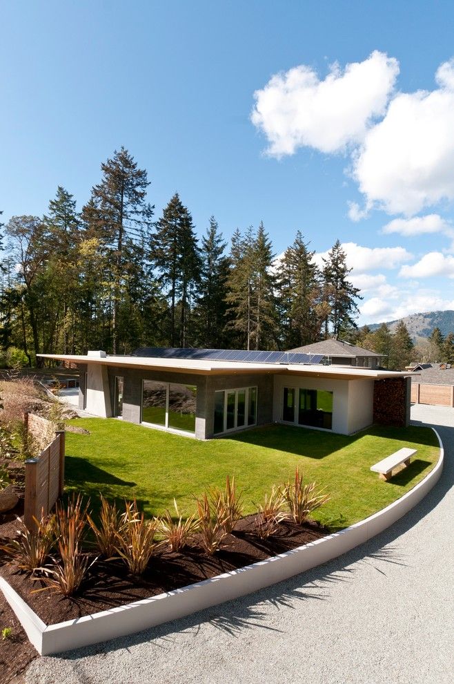 Pacific Energy Wood Stove for a Contemporary Landscape with a Solar Panels and Wain Rd   Pre Cast Insulated Concrete Panel Passive Solar Home by Nz Builders Ltd