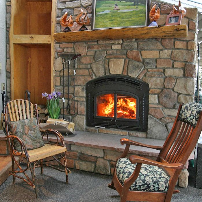 Pacific Energy Wood Stove for a Rustic Living Room with a Stone Slab and Fireplace Installs by Inglenook Energy Center