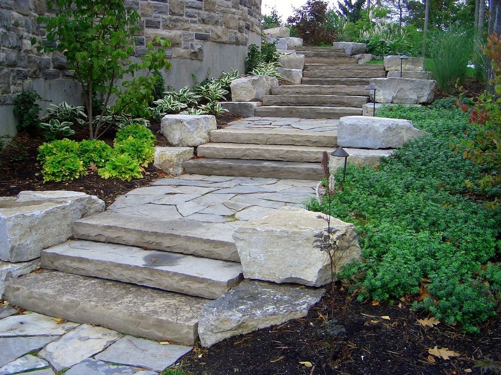 Pavestone for a Rustic Landscape with a Natural Stone Stairs and Country Squire Road by Ross Yantzi's Pavestone Plus Ltd.