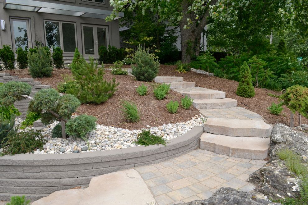 Pavestone for a Rustic Staircase with a Rock Wall and William Street Front Entrance by Ross Yantzi's Pavestone Plus Ltd.