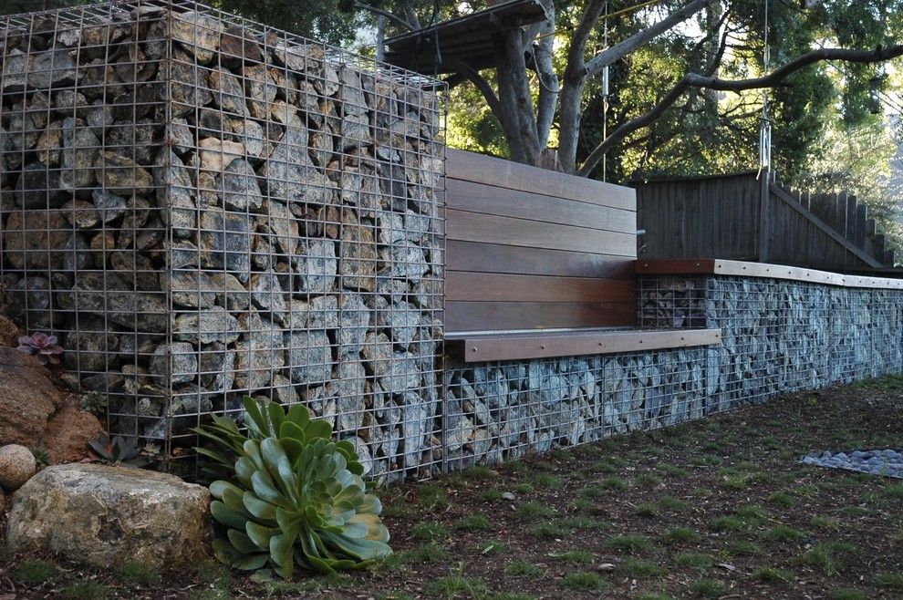 Pilings for a Contemporary Landscape with a Stone and Serpentine Stone by Jeffrey Gordon Smith Landscape Architecture