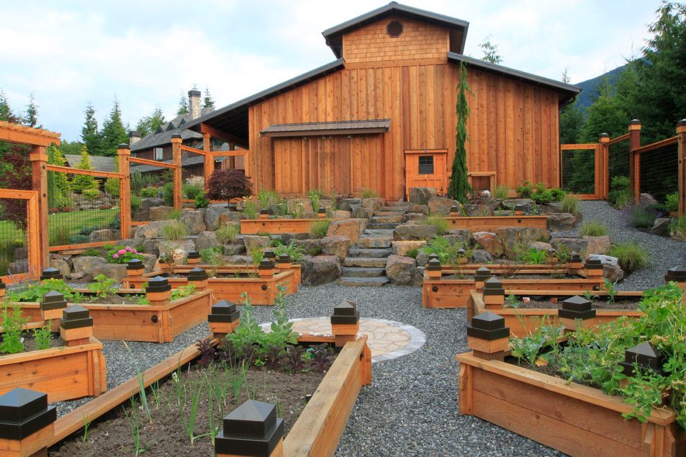 Railroad Tie Retaining Wall for a Eclectic Exterior with a Seating and We Add Fire, Water and Light! by Alderwood Landscape Architecture and Construction