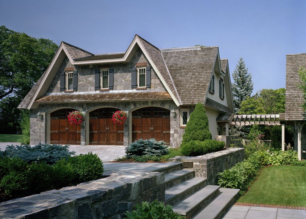 Railroad Tie Retaining Wall for a Traditional Garage with a Planting and Storybook by Siemasko + Verbridge