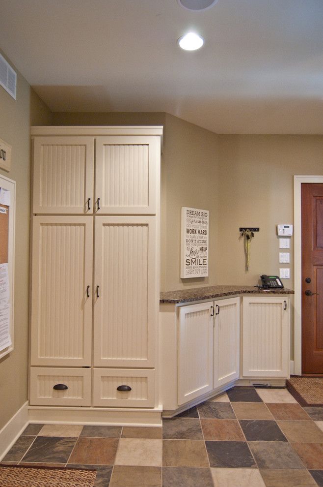 Raynor Doors for a Rustic Entry with a Brookhaven Cabinets and Country Estate by Troxel Custom Homes