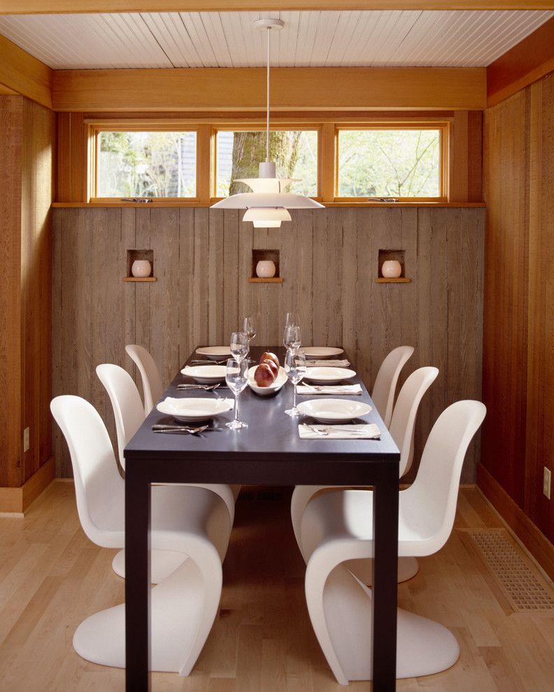 Reupholster Chair Cost for a Contemporary Dining Room with a Panton Chair and Dining Room with Board Formed Concrete Walls by Giulietti Schouten Architects