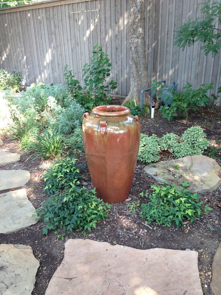 Roundtree for a Eclectic Landscape with a Texas Tough and Natural Back Yard with Water Feature by Roundtree Landscaping, Inc