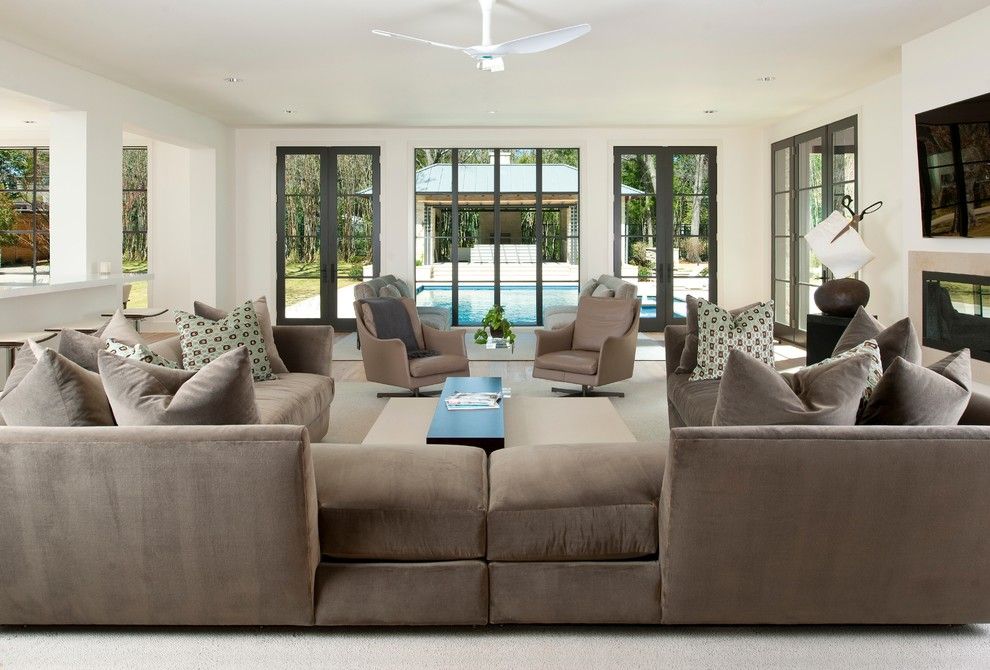 Scissor Doors for a Contemporary Family Room with a Neutral Tones and Northaven by Tatum Brown Custom Homes