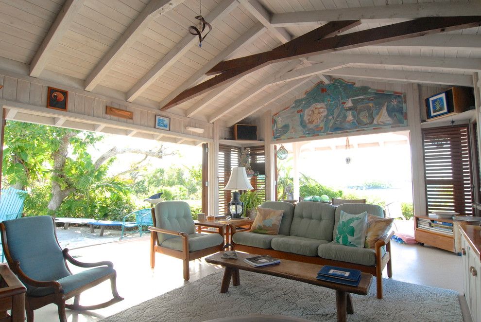 Scissor Doors for a Tropical Living Room with a Wood Coffee Table and Bahamian Open House by Brenda Olde