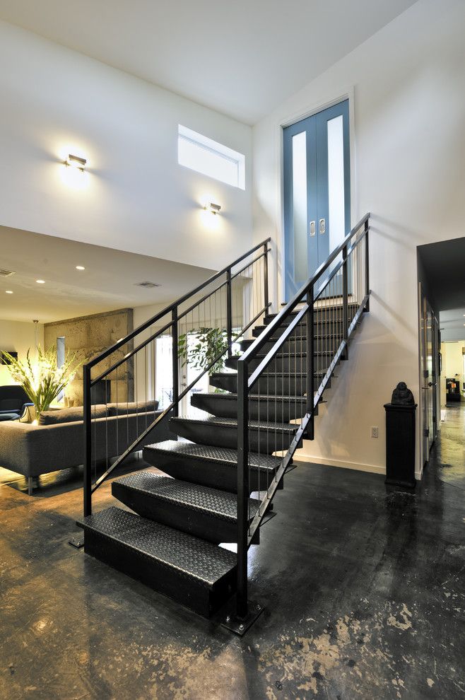 Sconces Definition for a Industrial Staircase with a Dark Floor and Custom Stair by Rd Architecture, Llc