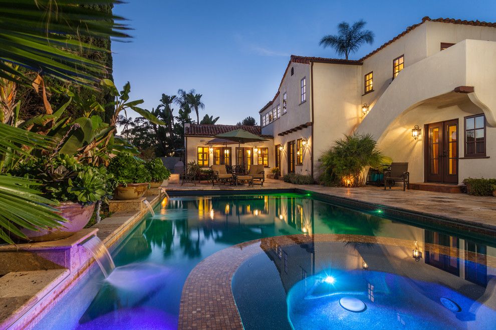 Serenity Med Spa for a Mediterranean Pool with a Clay Tile Roof and 1920's Historic Riley House. by Distinguished Pools