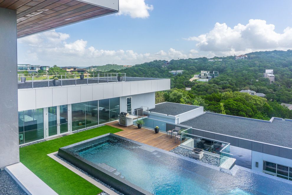 Simply Austin Furniture for a Modern Pool with a Luxury Backyard and West Lake Hills Infinity Edge Pool & Decks (Ipe, Cable Railing) by Timbertown