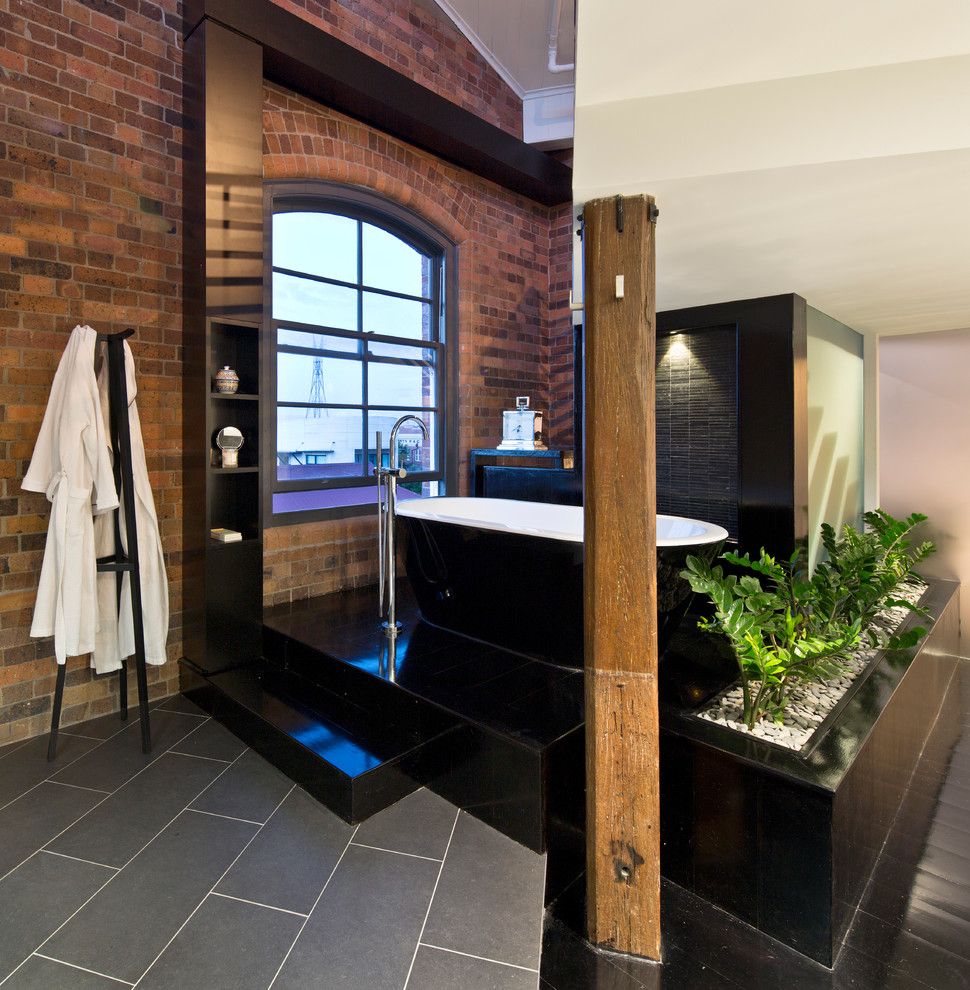 Sioux City Brick for a Industrial Bathroom with a Floor Mount Faucet and the Carson Woolstore by Tonic Design