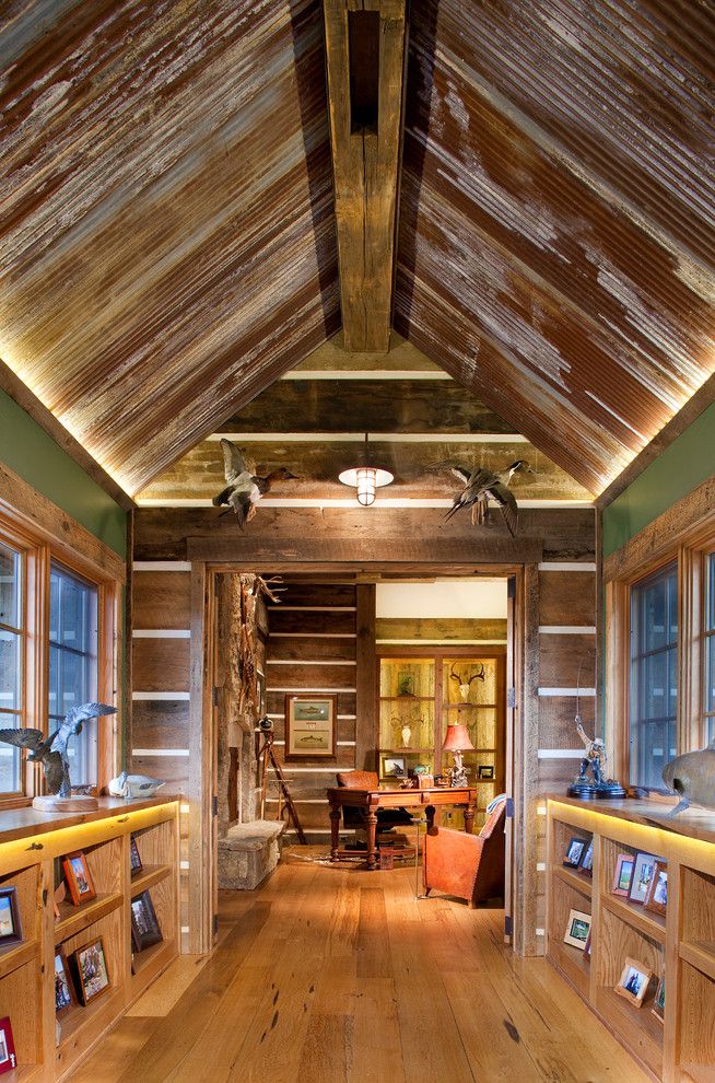 Skunk Smell in House for a Rustic Hall with a Caged Pendant Light and Mine Style Rustic Mountain Lodge by Copper Creek Homes, Llc