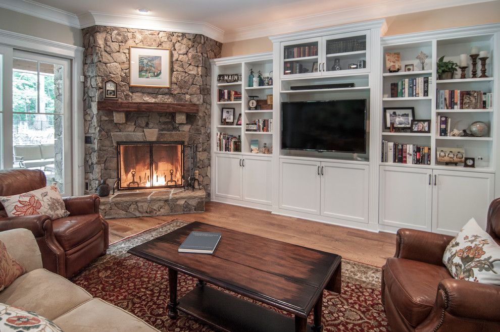 Soundbar vs Surround Sound for a Traditional Family Room with a Stone Fireplace Surround and the Nalwasse Project by Kdh Residential Designs