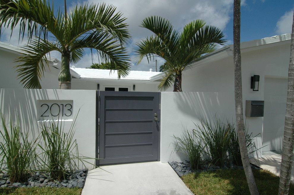 Spring Cleaning Checklist for a Tropical Entry with a White Exterior and Modern Renovation by Schachne Architects & Builders