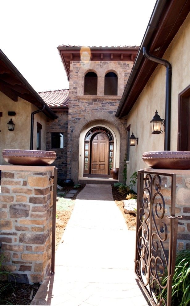 Sto Stucco for a Mediterranean Entry with a Wall Lighting and Exterior Entry by Aneka Interiors Inc.