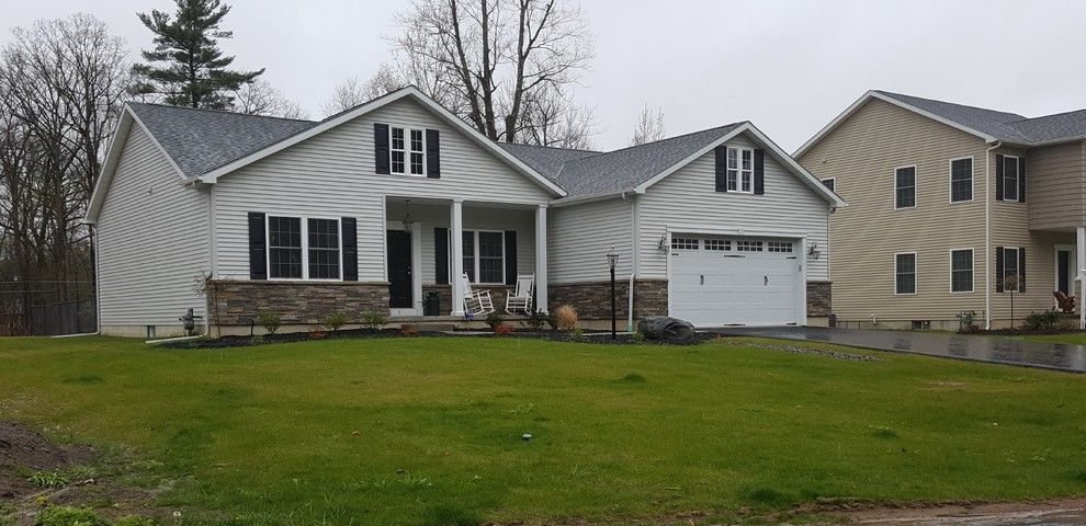 Sunland Shutters for a Contemporary Garage with a Black Door and Carriage House Doors by Empire Overhead Doors, Llc