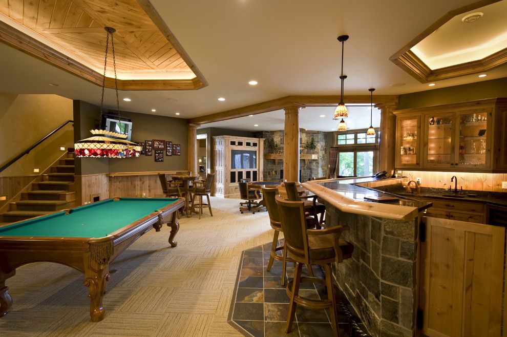 Tile and Stone Warehouse for a Traditional Family Room with a Basement Bar and Recreation Room by Nor Son, Inc.