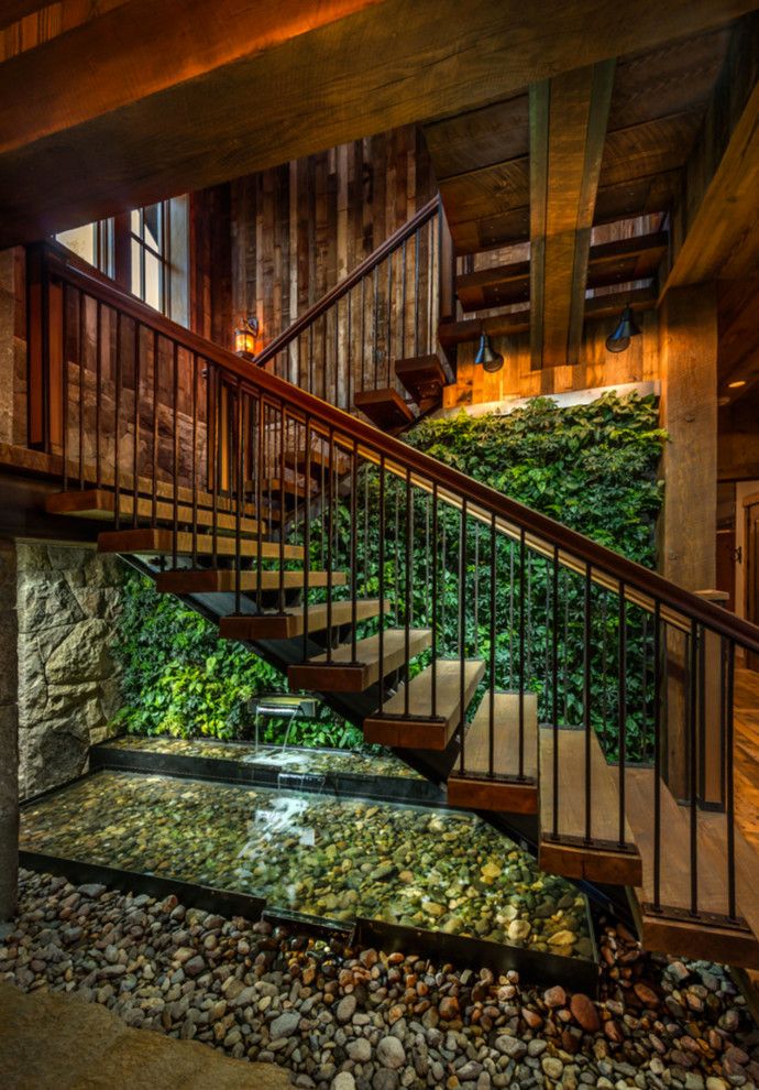 Truckee Meadows Water for a Rustic Staircase with a Stone Wall and Sustainable Mountain Home by Heller Construction, Inc.