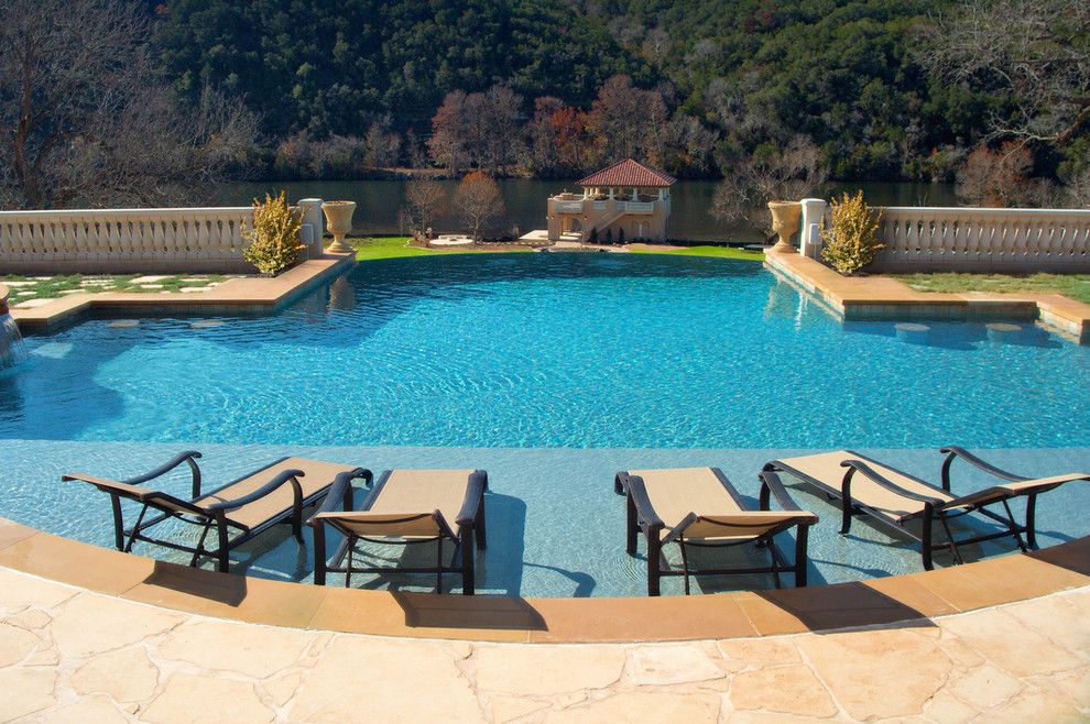 Wade Jurney Homes for a Traditional Pool with a Stone Railing and Luxury Backyards by Cody Pools, Inc.