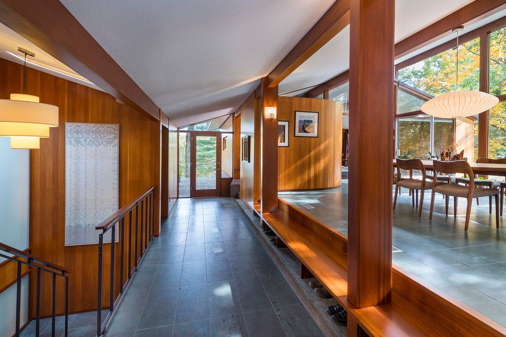 Walter Gropius for a Midcentury Dining Room with a Floor to Ceiling Glass and Sculpted to the Land by Flavin Architects
