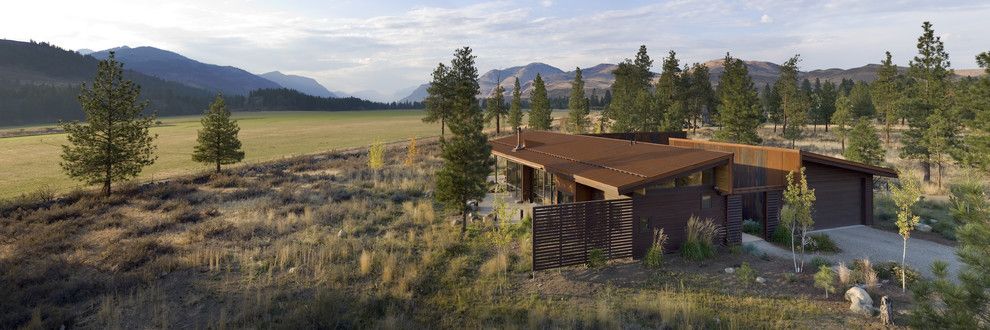 Weathering Steel for a Modern Exterior with a Screened Yard and Wolf Creek by Prentiss Balance Wickline Architects