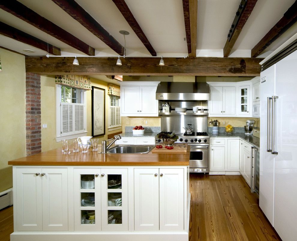 Whistling Kettle for a Traditional Kitchen with a Wood Cabinets and Crystal White Painted Inset by Kleppinger Design Group, Inc.