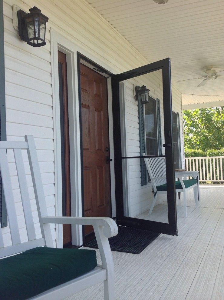 Window Tint Columbus Ohio for a Farmhouse Entry with a Storm Door Columbus and Fiberglass Entry Door with a Cherry Stain in Carroll Ohio by Innovate Building Solutions