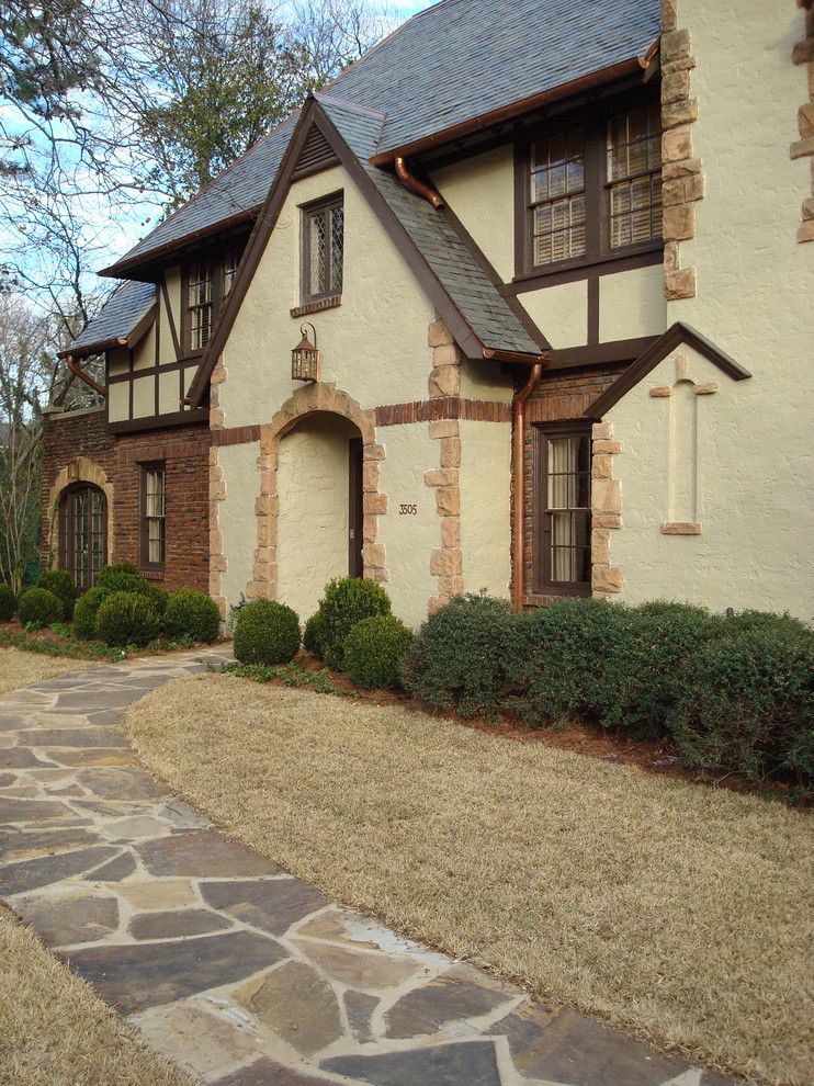 Woerner Turf for a Traditional Exterior with a Copper Downspouts and Tudor Entry by Studio C Architecture & Interiors