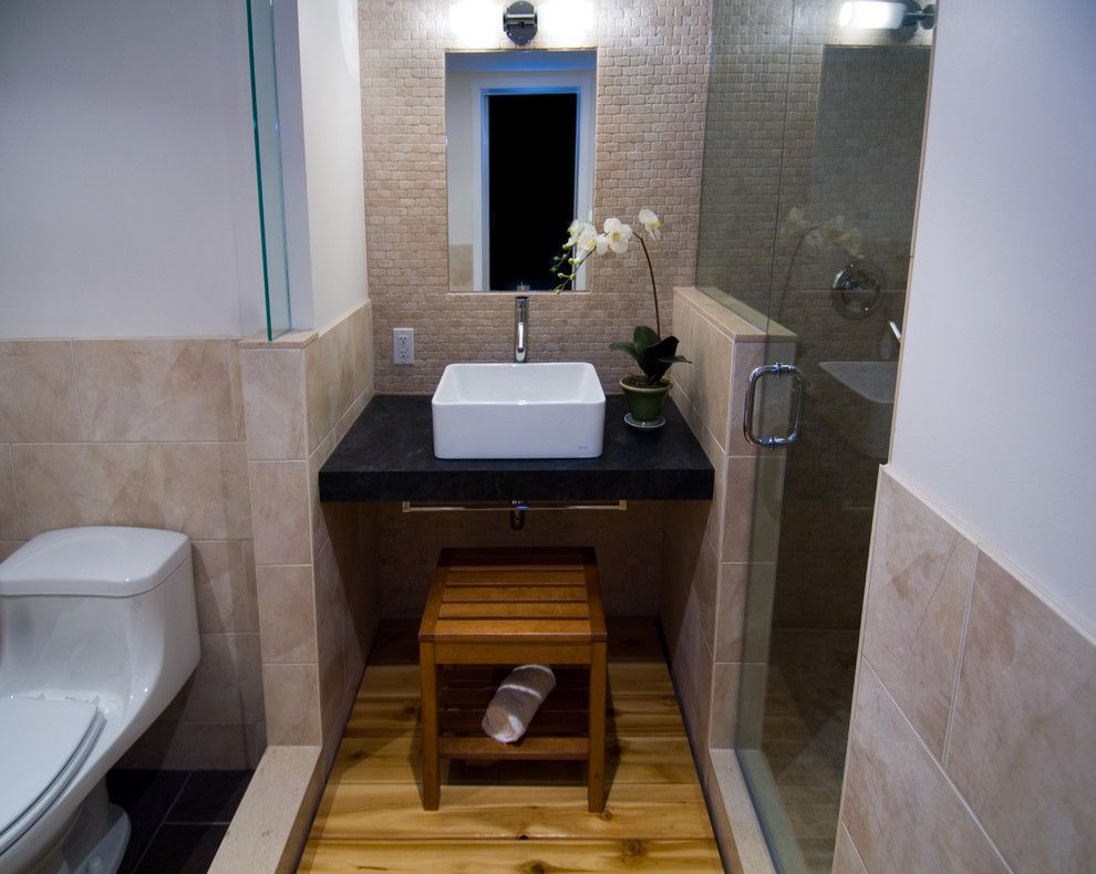 Woodgrain Doors for a Asian Bathroom with a Black Counter and Japanese Modern by Biglarkinyan Design Planning Inc.